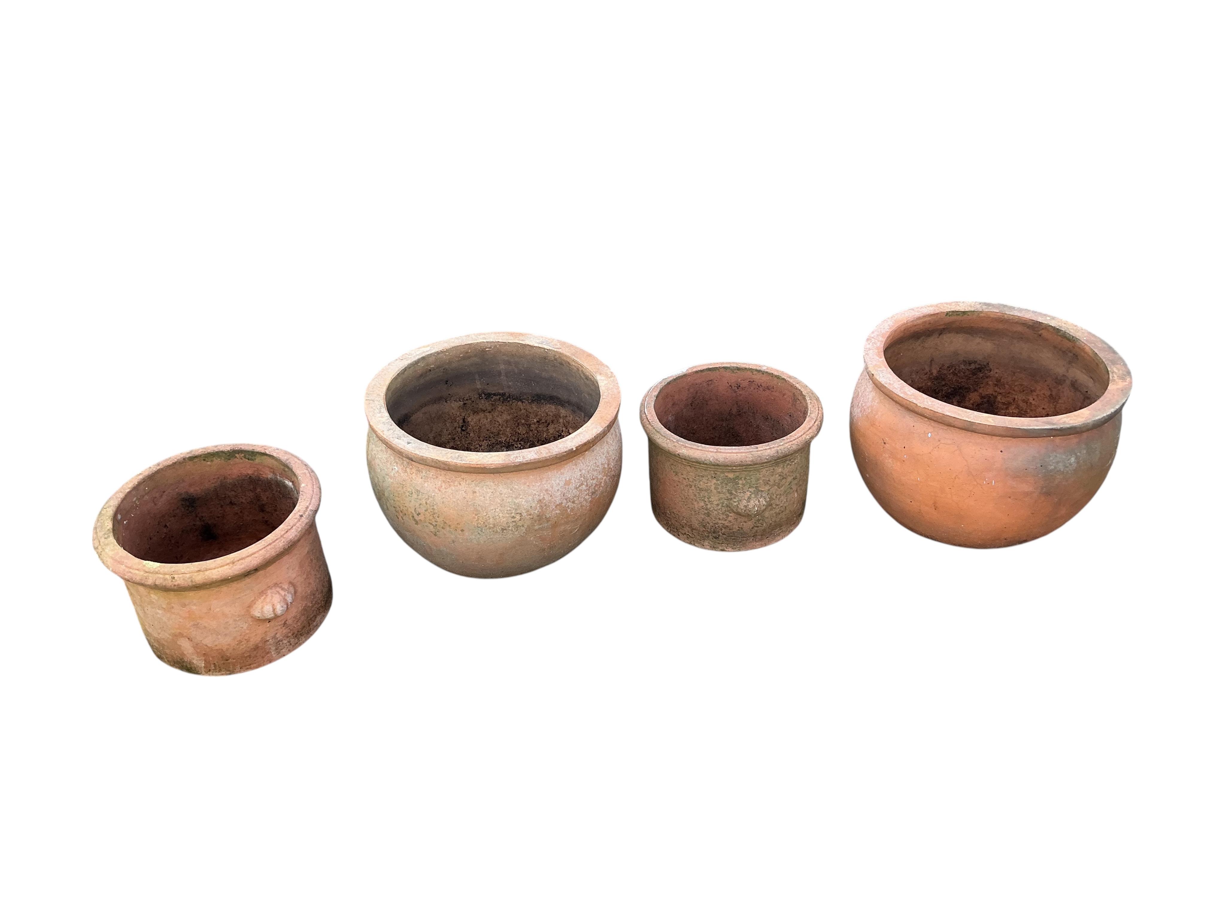 Two pairs of circular terracotta garden planters, larger diameter 40cm